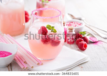 Raspberry lemonade with ice in a glass