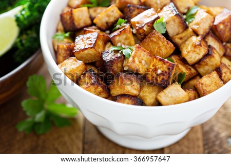 Stir fried tofu in a bowl with sesame and greens