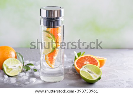 Infused water with orange and lime in a bottle
