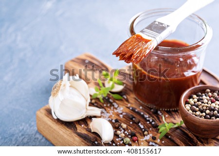 Barbeque sauce with a basting brush in a jar