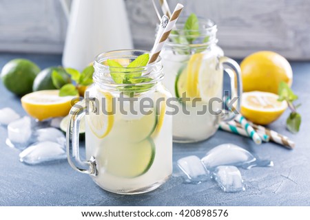 Fresh citrus lemonade with limes and lemons in mason jars