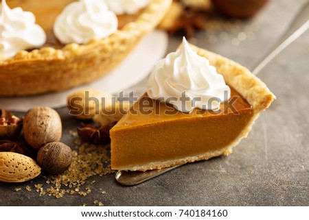 Sweet pumpkin pie slice decorated with whipped cream
