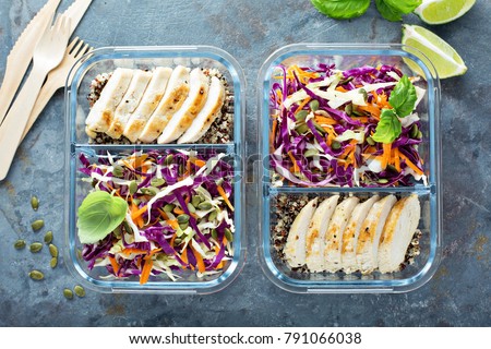 Healthy meal prep containers with quinoa, chicken and cole slaw overhead shot