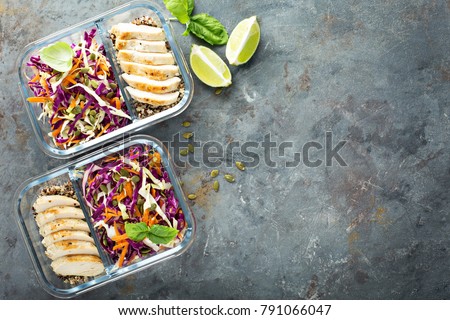 Healthy meal prep containers with quinoa, chicken and cole slaw overhead shot with copy space