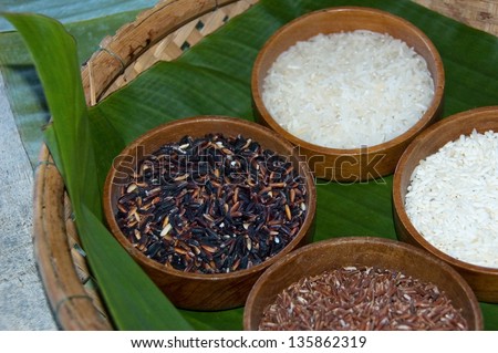Different types of rice in wooden plates on the banana leaf prepared for cooking