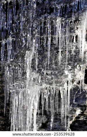 Icicles hanging down from a stone ledge