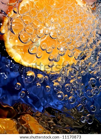 Splash with fresh citrus. Pure water. Blue background.