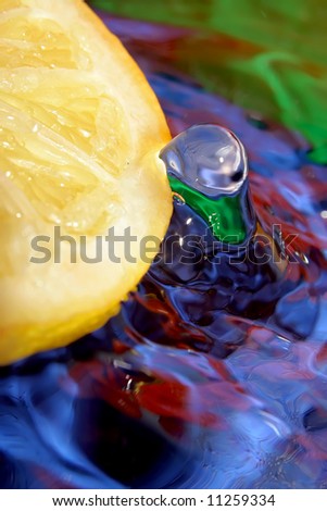 Splash with fresh lemon. Pure water. Blue background.