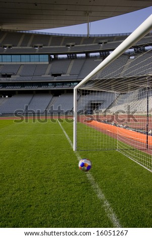 Ball heading the goal line in en empty stadium