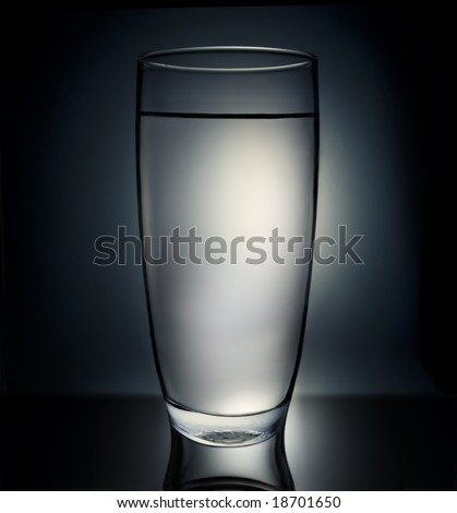 Glass full of water in a back lit setting