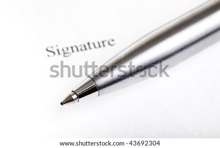 Ballpoint metal pen on contract paper extreme macro
