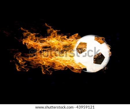 Classic football in flames on black background