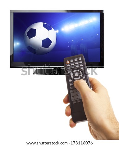 Male hand holding remote control with a football game on screen isolated on white