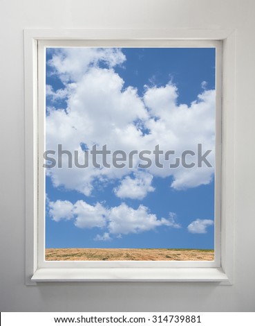 Modern residential window with a view of clouds and field