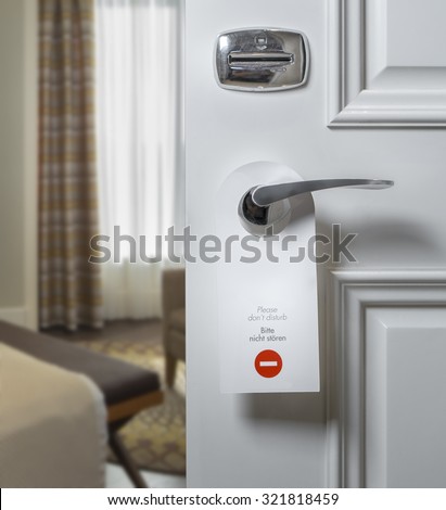 Do Not Disturb sign on hotel room\'s door handle