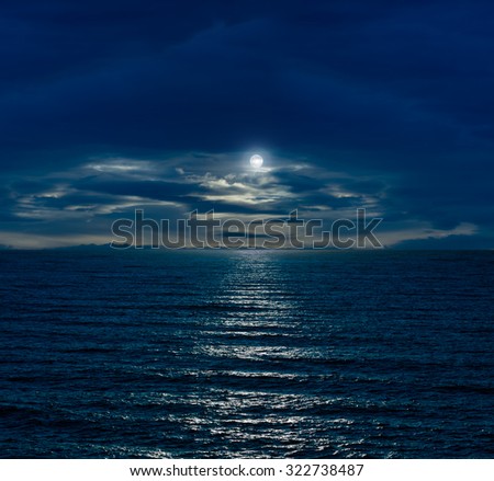 Night sky with full moon and reflection in sea and clouds
