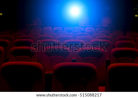 Empty movie theater with projection light falling into the lens