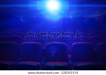 Empty movie theater with projection light falling into the lens