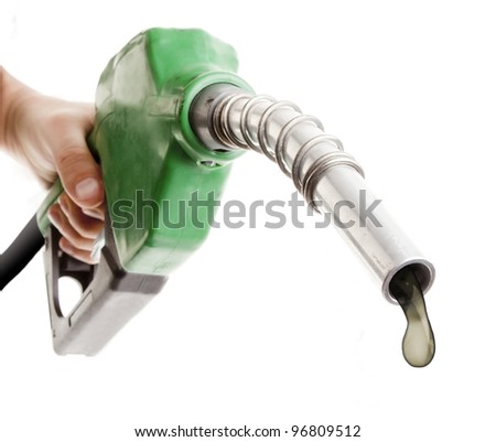 Male hand holding gas pump isolated on white with one last drop of fossil fuel