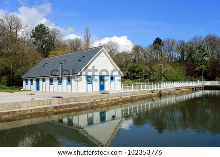 Dressing room on open air theater reflected on lake in summer with blue sky background, Scarborough, England.