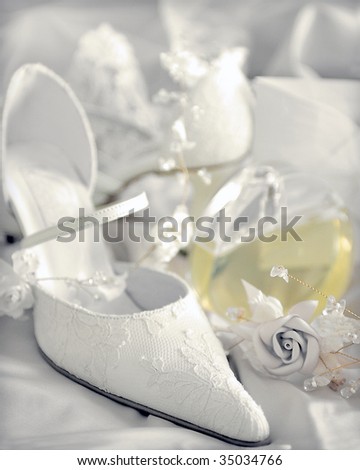 stock photo White bridal wedding shoes next to decorative rose