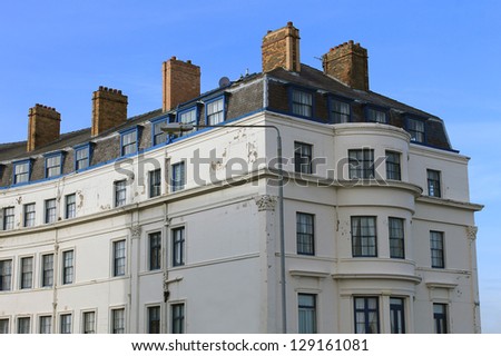 Exterior of old hotel building with blue sky background.