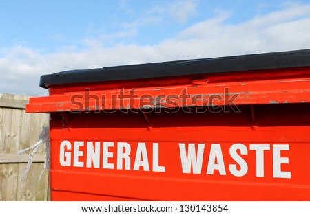 Industrial general waste bin with cloudscape background.