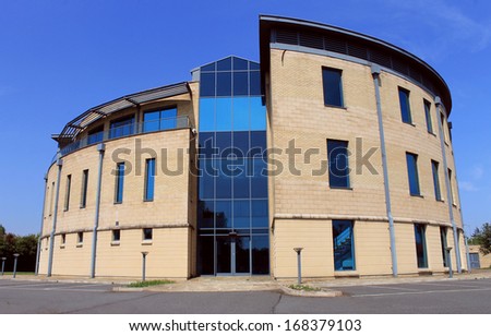 Exterior of empty modern office building available for lease or rent with blue sky background.