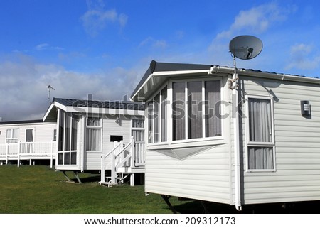 Scenic view of a caravan or trailer park in summer with blue sky and cloudscape background.