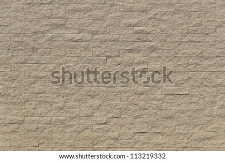 Sand stone bricks pattern on sunny day.