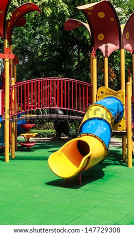 Colorful Spiral Tube Slide with Green Elastic Rubber Floor for Children in the Park