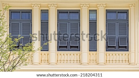 Retro Wooden Window with shutters in colonial architecture style building