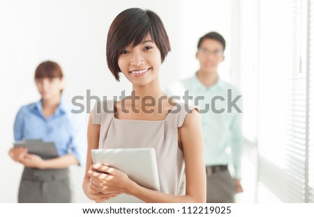 Portrait of business associates with a young female leader in the foreground