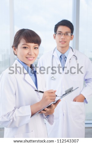 Portrait of smiling female practitioner looking at camera in hospital