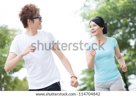 Happy couple jogging on a lovely summer day