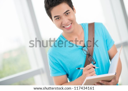 Portrait of a smart-looking college student smiling at the camera