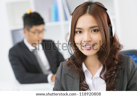 Pretty customer support representative with a pleasant smile working from office