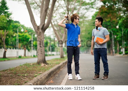 Cool teenagers meeting in the park to spend time