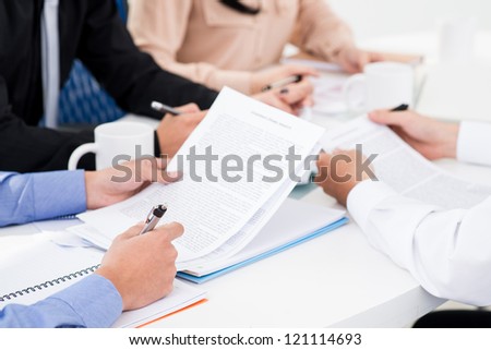 Group of business workers considering the term of the agreement
