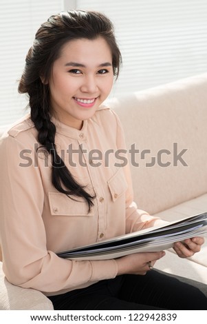 Vertical portrait of a young secretary with a cute smile