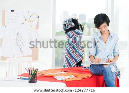 Girl sitting on the table and drawing