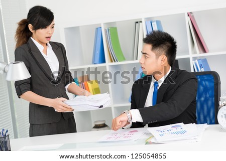 Man showing woman what time it is because she is late