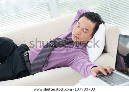 Portrait of a businessman sleeping on the couch