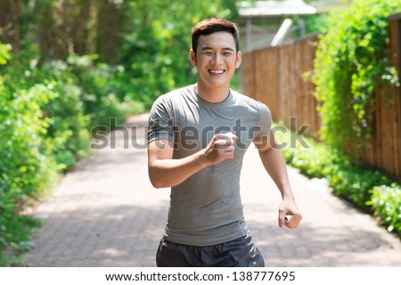 Image of a laughing jogger going in for sports outside