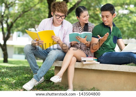 Cheerful students discussing something outside
