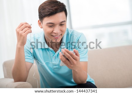 Excited guy being about to listen to a cool new song on his mp3-player