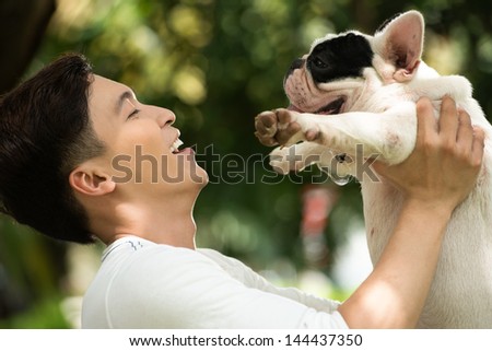 Smiling Owner Holding His Friendly Pet With Affection