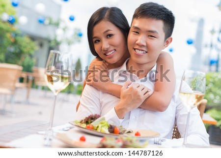 Portrait of a charming young woman giving her beloved a tight hug