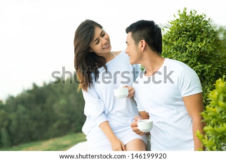 Image of a young couple meeting the morning on the balcony