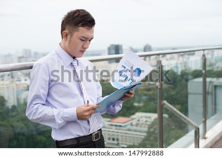 Copy-spaced image of a working businessman standing outside
